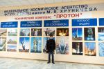 Photo near stand of photos from technical complex "Buran" 